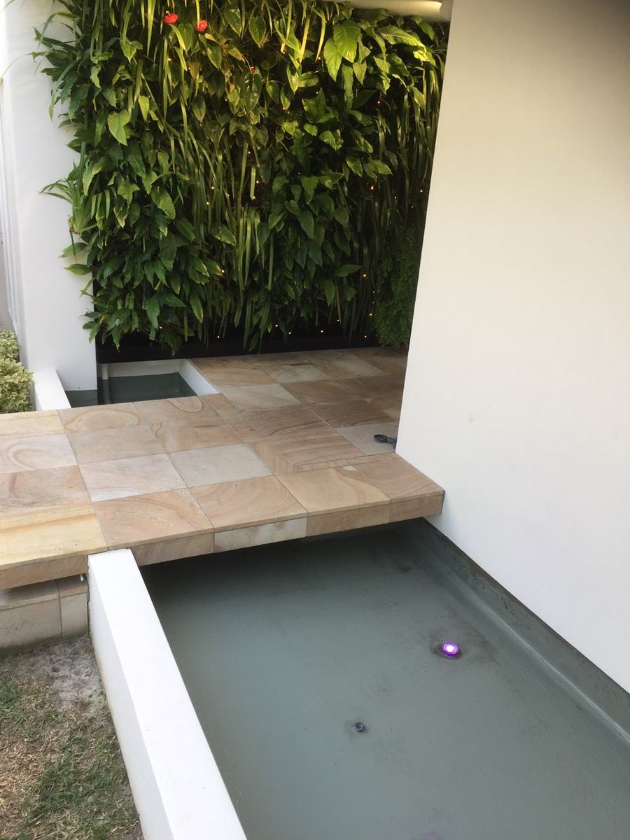 Waterproofed water feature beside a living wall